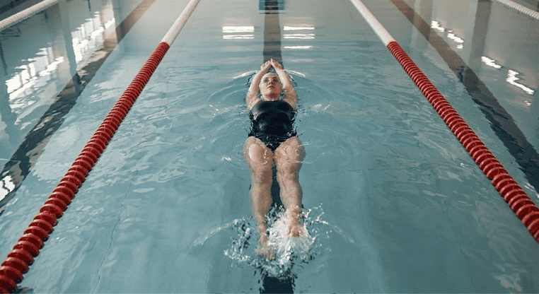 Swimmer Doing Breaststroke Kick Drill on Back