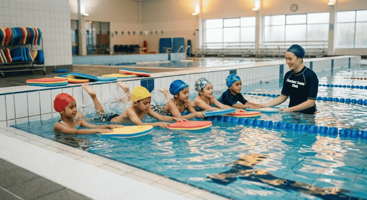 Children practicing freestyle kick in Rocket swim lesson